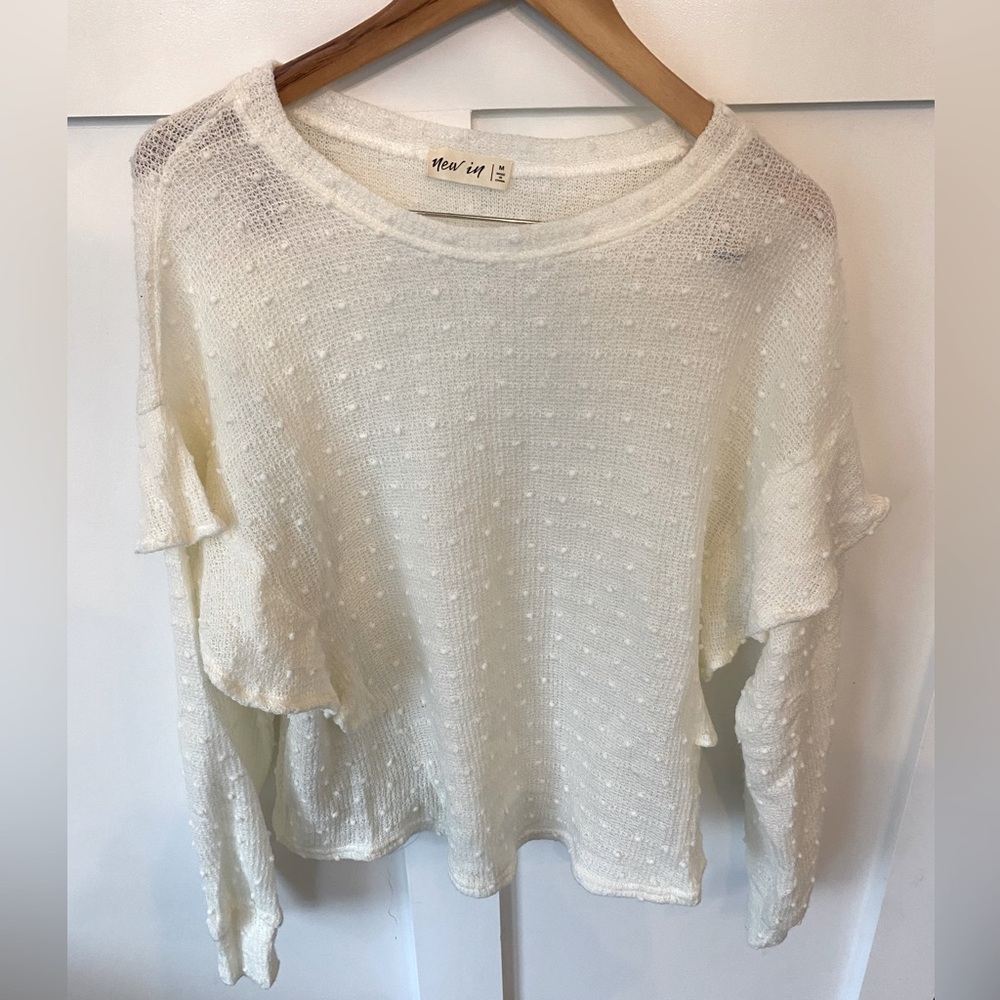 Oversized white sweater with ruffle detail
